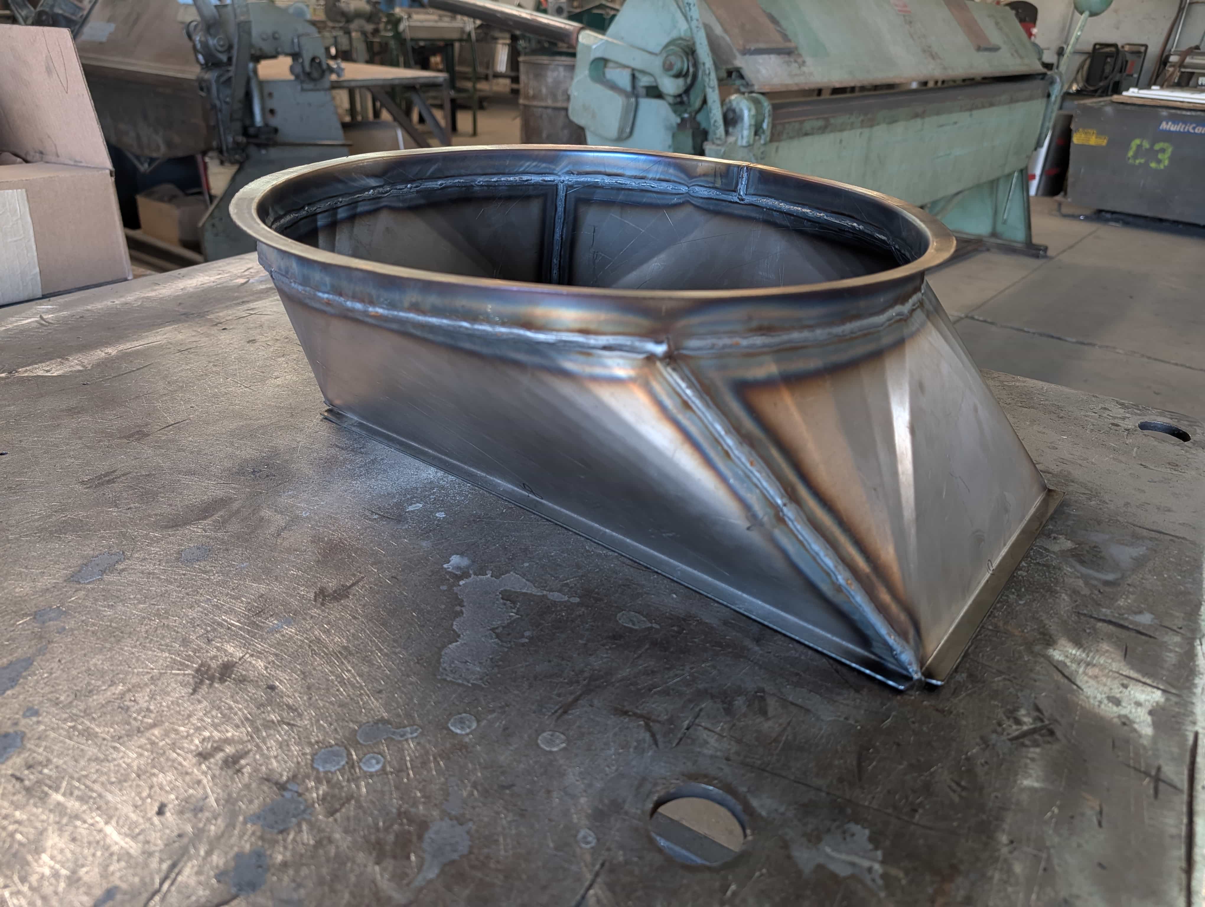 Formed round custom duct piece on a fabrication table