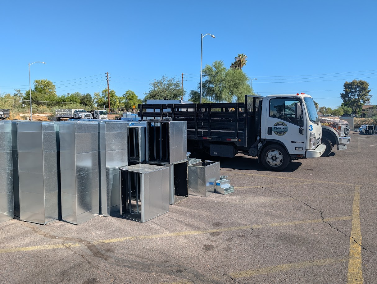HVAC ductwork staged near an Empire delivery truck